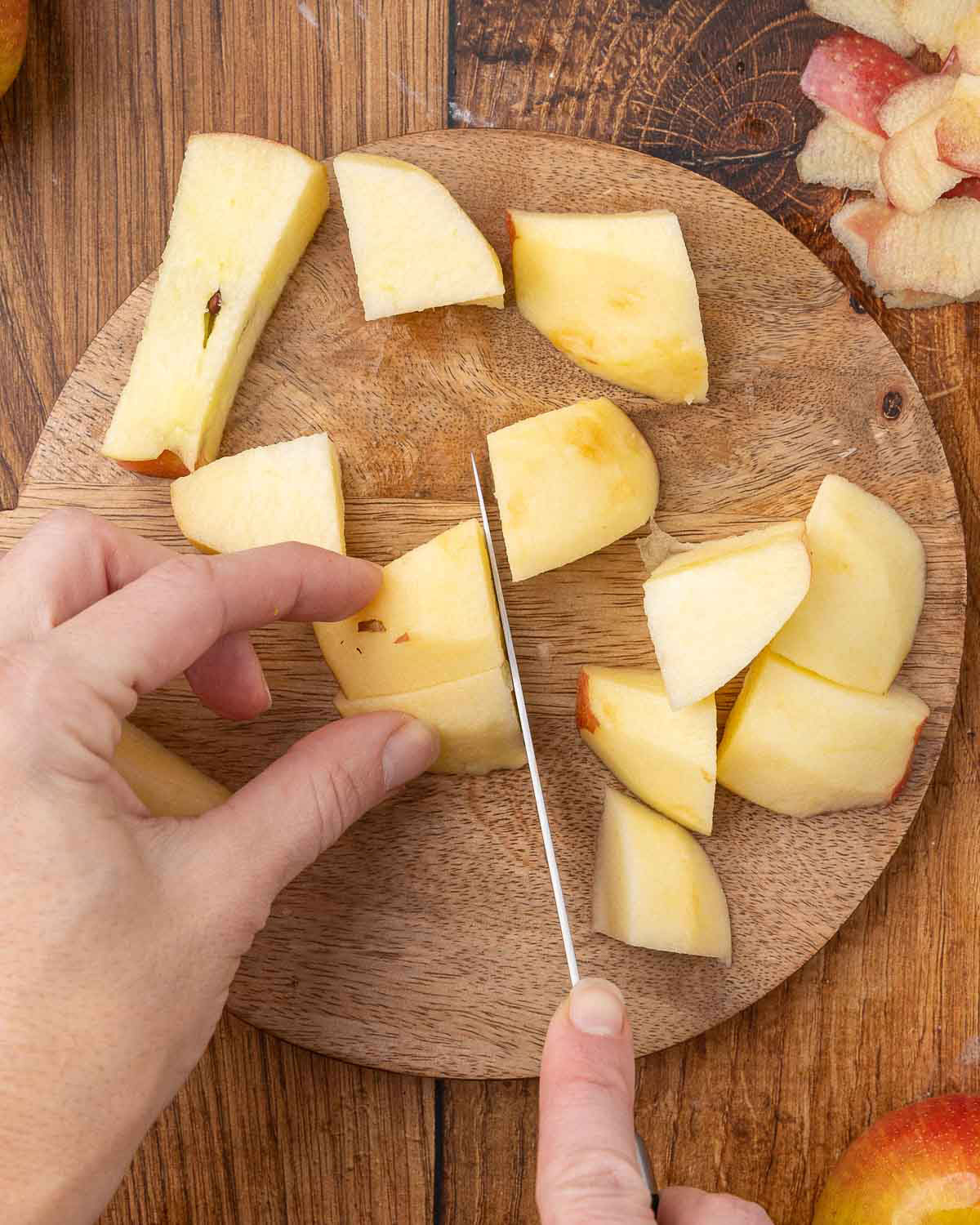 Chopping peeled and cored apples into large pieces.