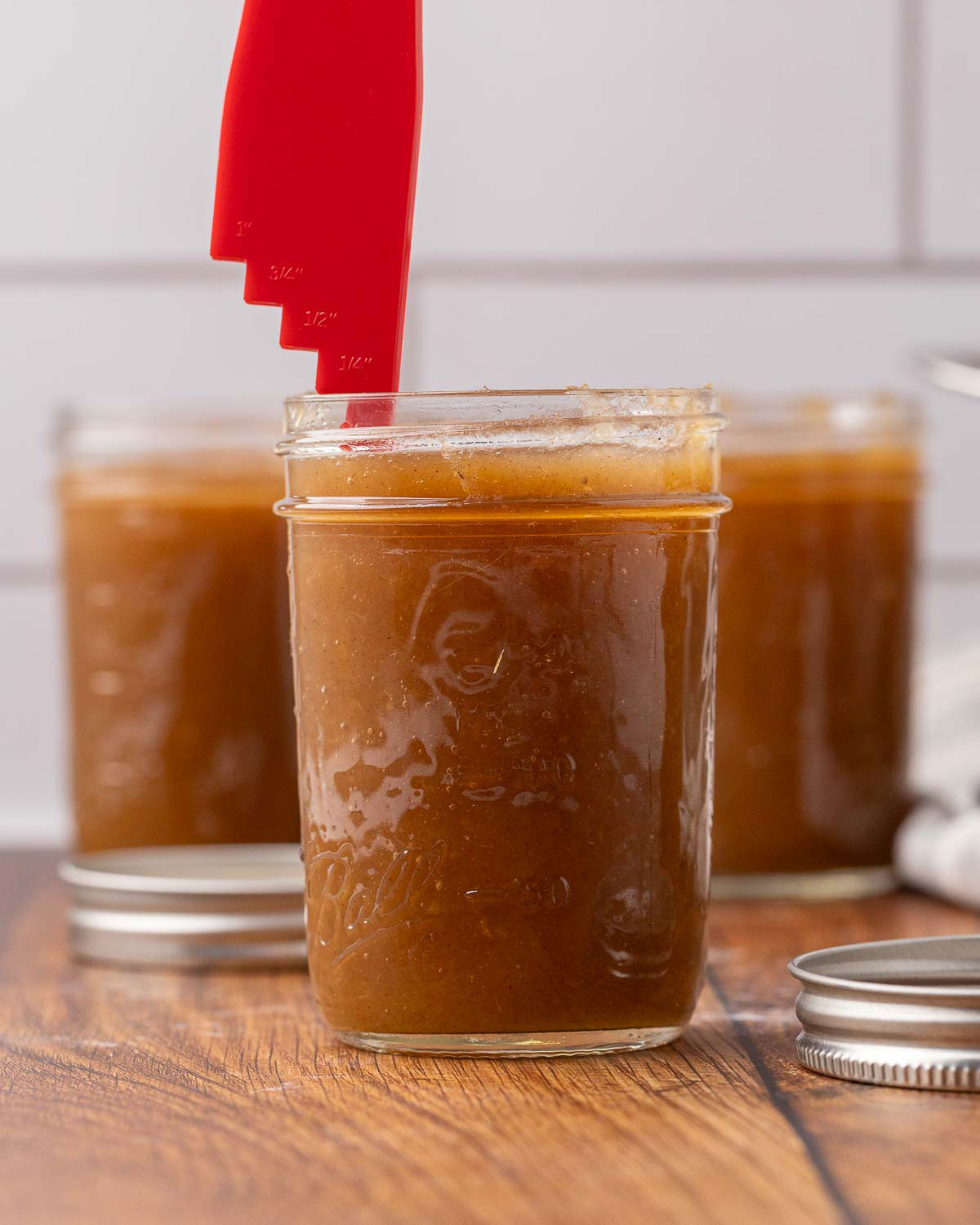 Apple butter in jelly jars with 1/4" measured headspace.