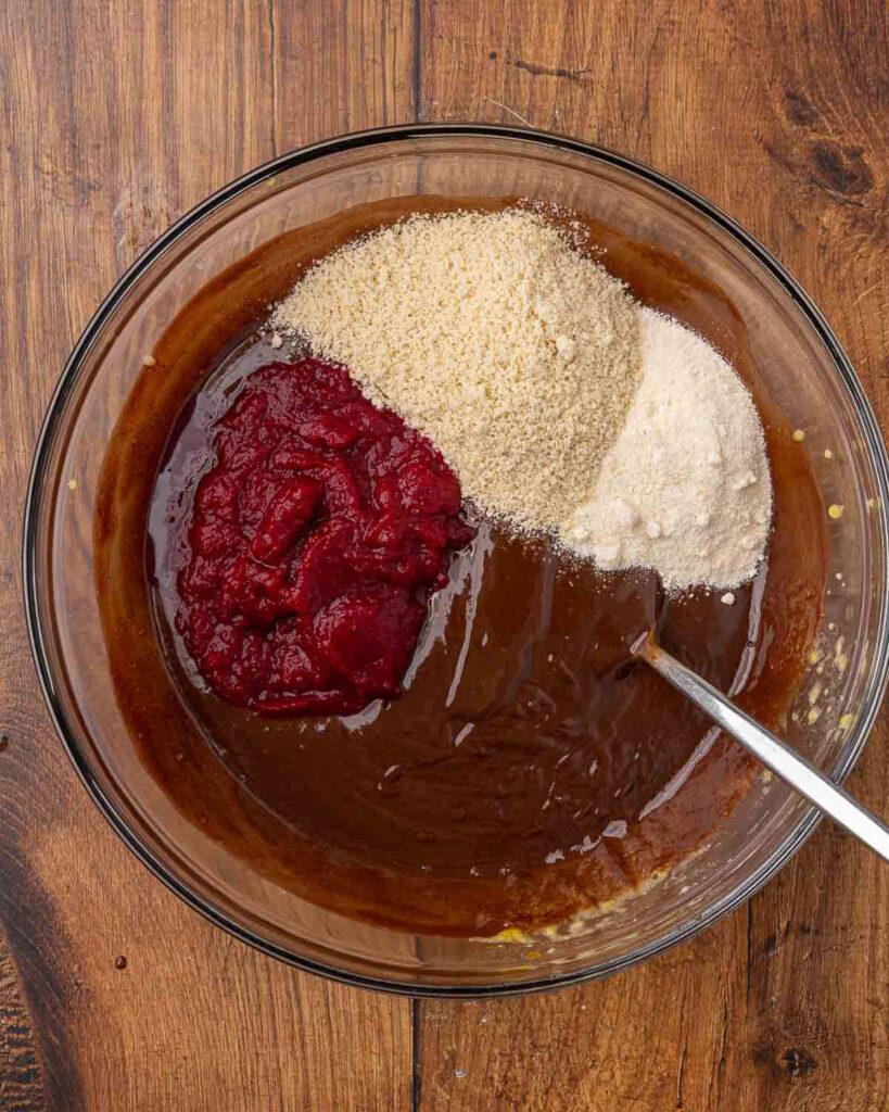 Adding pureed beets, coconut flour, and almond flour to the chocolate and egg mixture.
