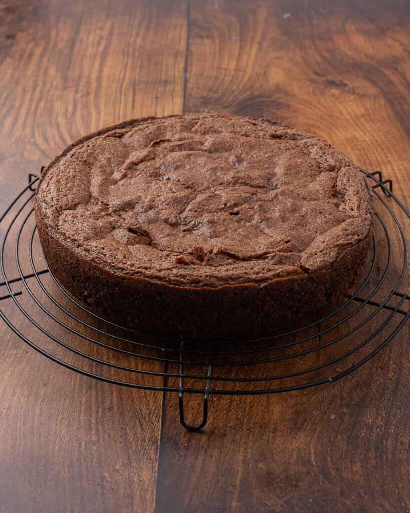 A freshly baked chocolate beet cake cooling on a wire rack.