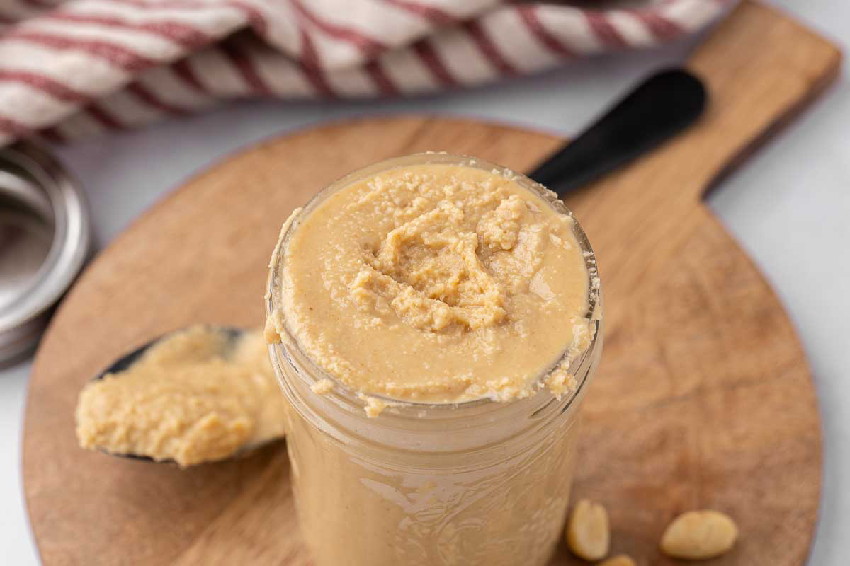 A pint jar full of homemade peanut butter.