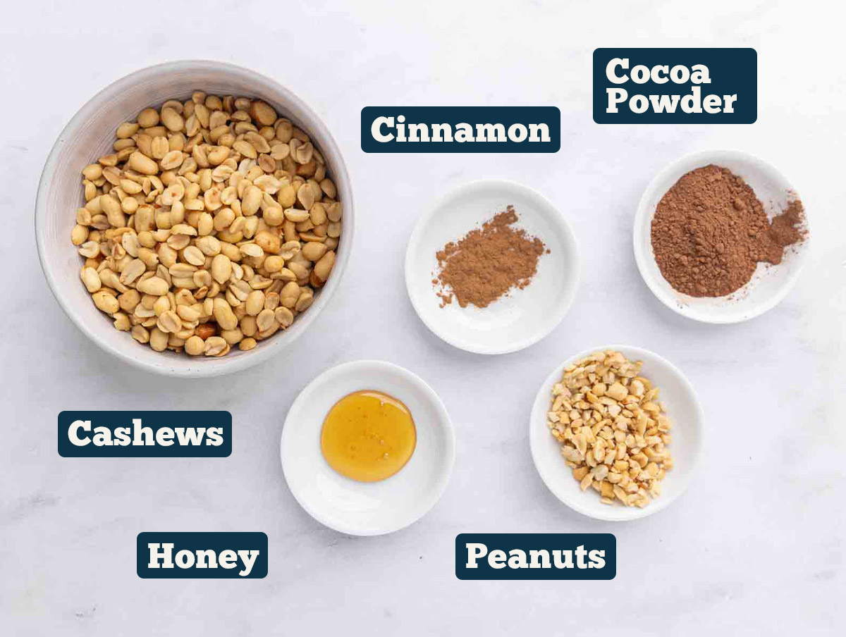 Homemade peanut butter ingredients: peanuts with optional ingredients (cinnamon, cocoa powder, cashews, and honey.)