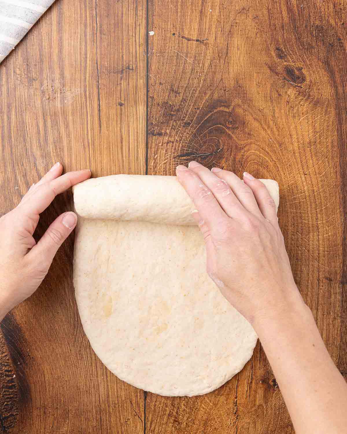 Sandwich dough being rolled into a log shape.