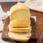 Sliced sourdough sandwich bread on a cutting board.