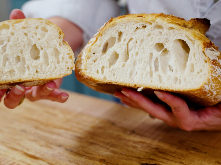 Showing the inner crumb of a sourdough boule.