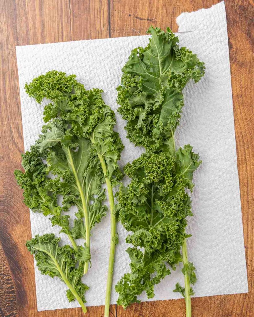 Washed kale drying on a paper towel.