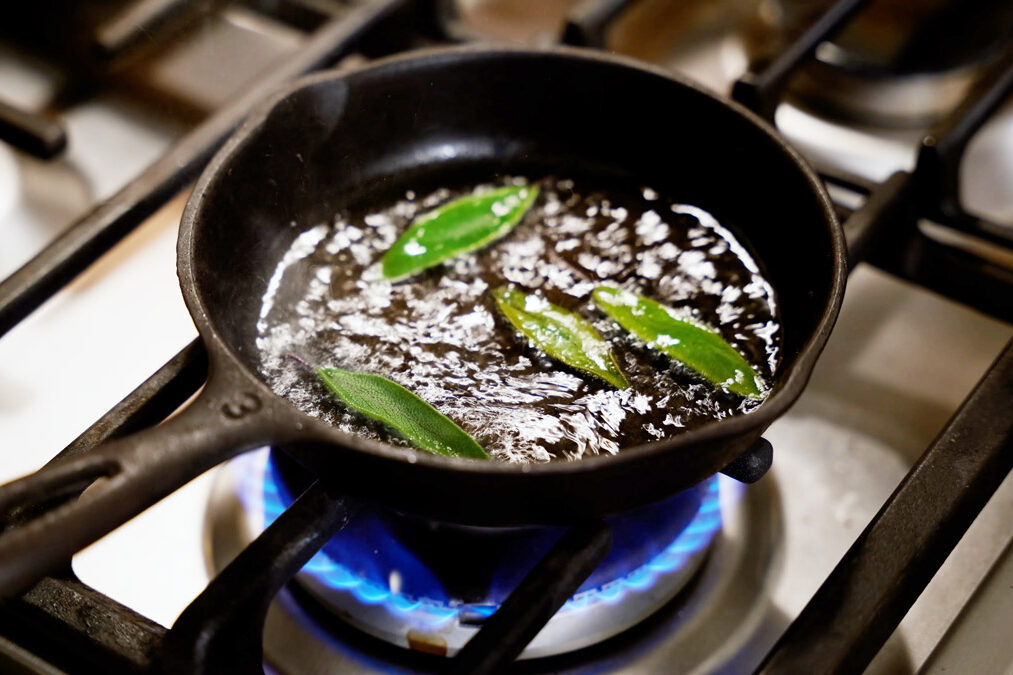 Sage leaves frying in oil.