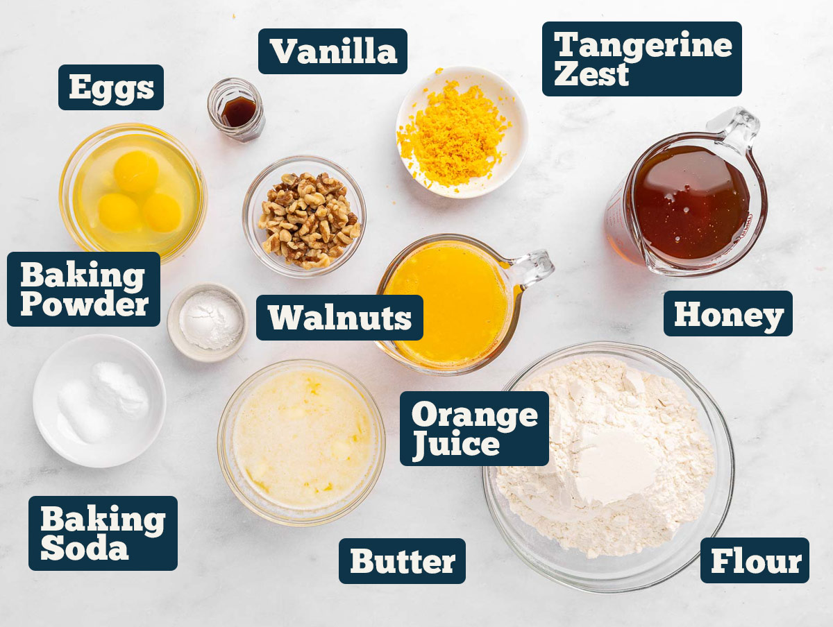 Tangerine cake ingredients: honey, butter, eggs, vanilla, orange juice, eggs, flour, baking powder, baking soda, and walnuts.