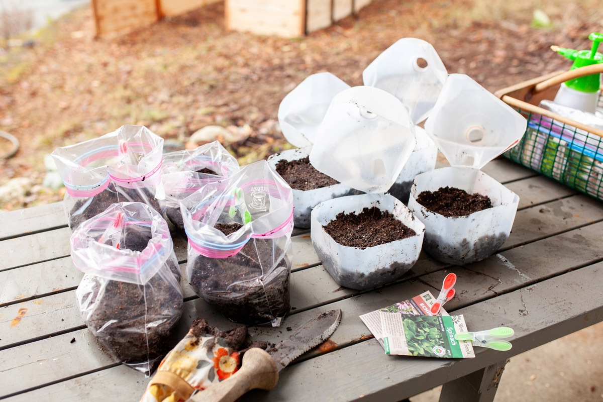 Winter sowing supplies on a wooden table.