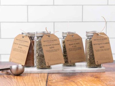 Jars filled with DIY seasoning mixes, and labeled with a tag.