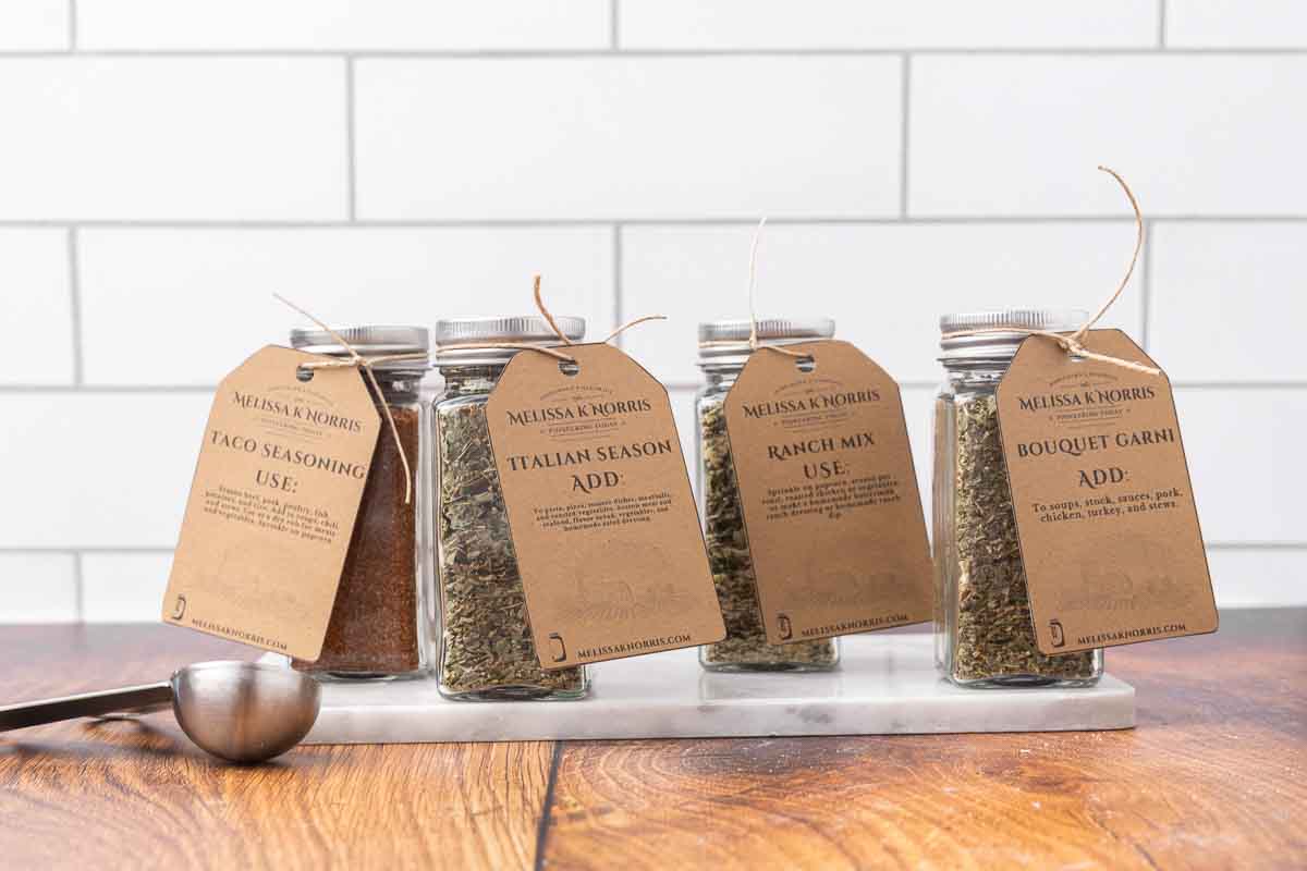Jars filled with DIY seasoning mixes, and labeled with a tag.
