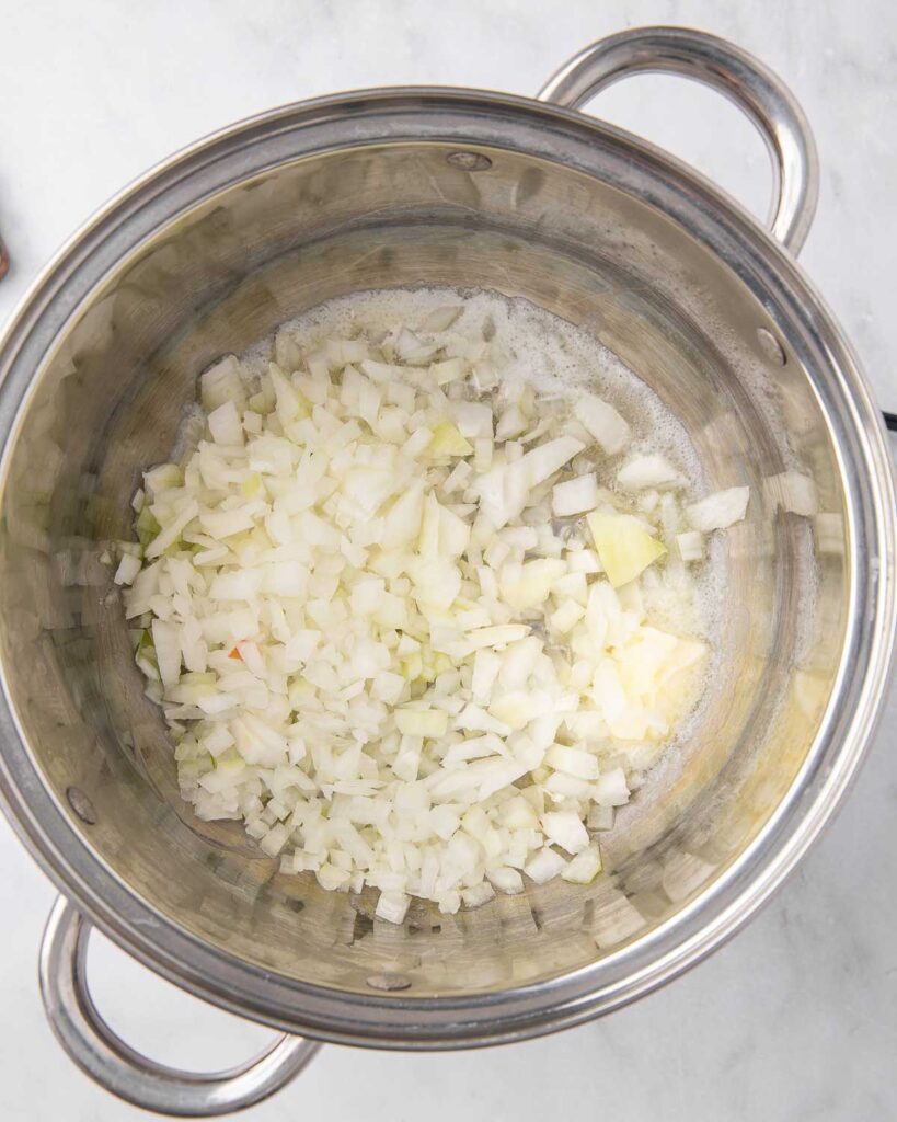 Onions and garlic saut&eacute;ing in a pan.