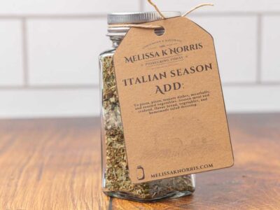A jar filled with DIY Italian seasoning mix, and labeled with a tag.