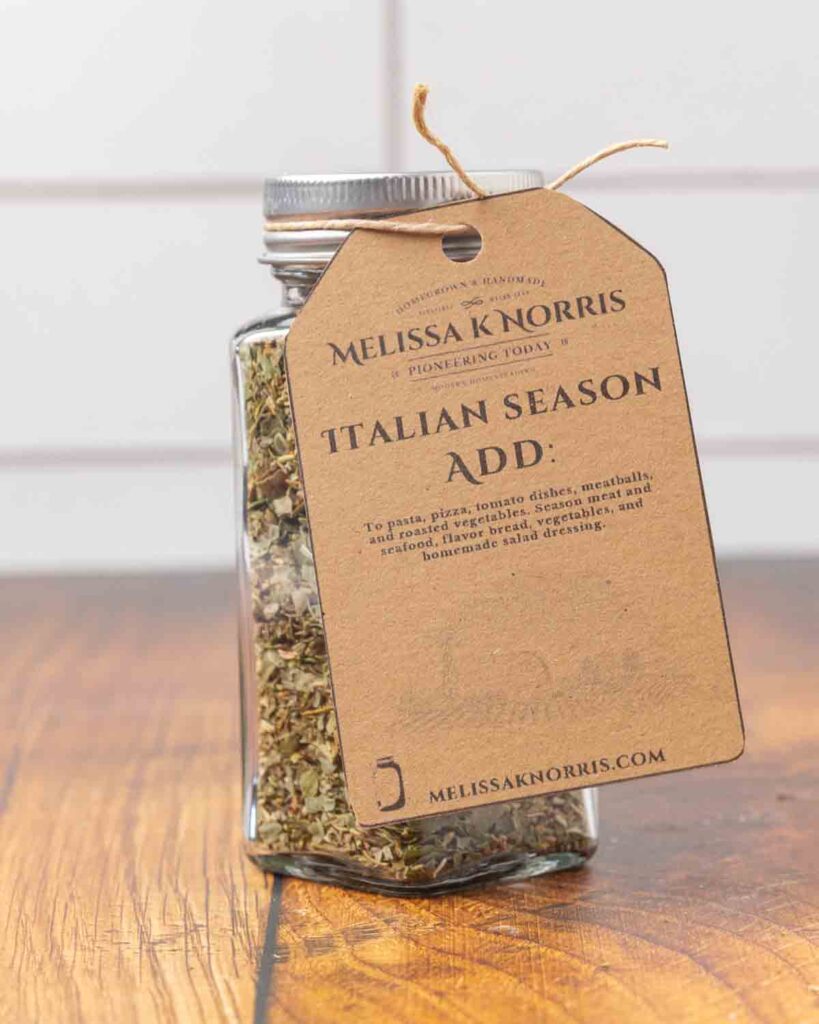 A jar filled with DIY Italian seasoning mix, and labeled with a tag.