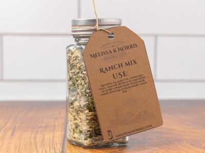 A jar filled with DIY ranch seasoning mix, and labeled with a tag.
