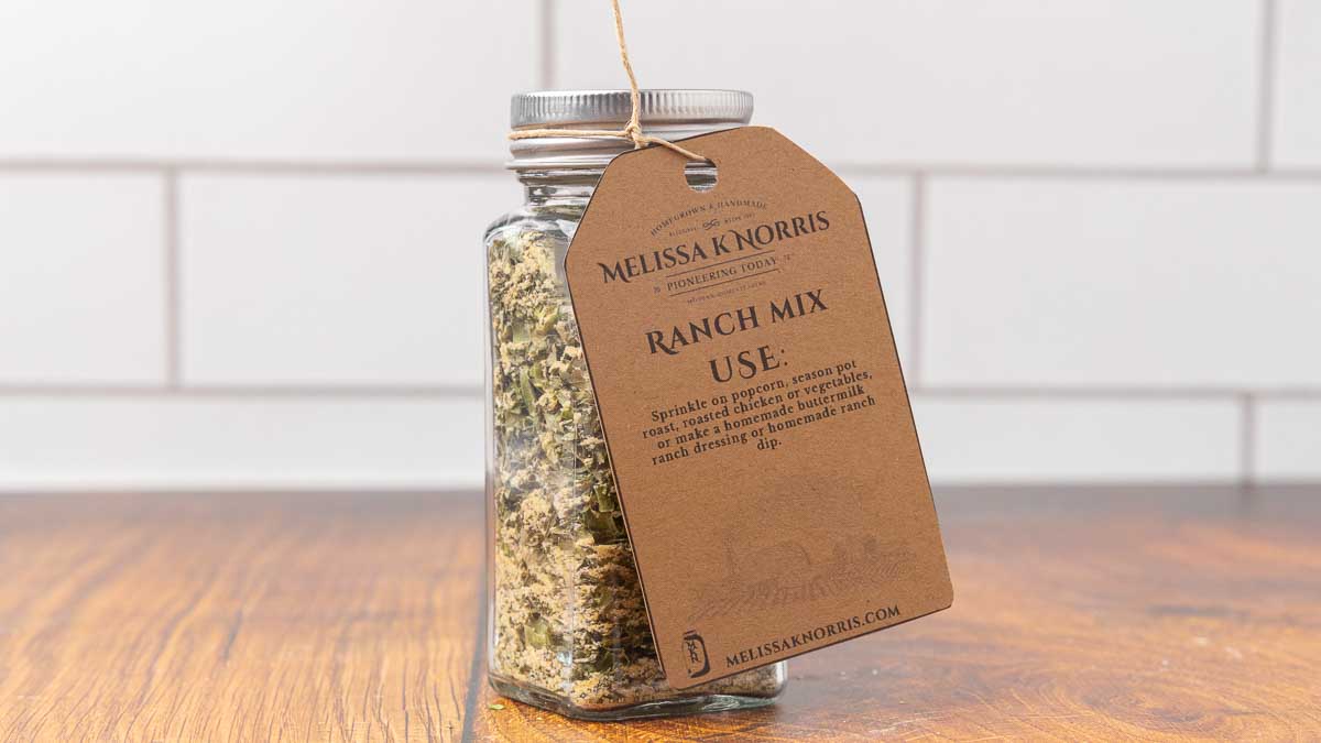 A jar filled with DIY ranch seasoning mix, and labeled with a tag.