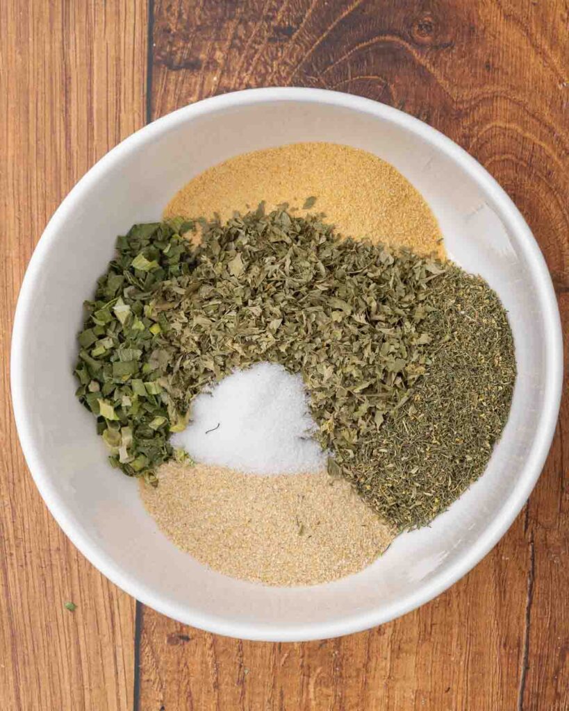 DIY ranch seasoning ingredients layered in a small bowl.