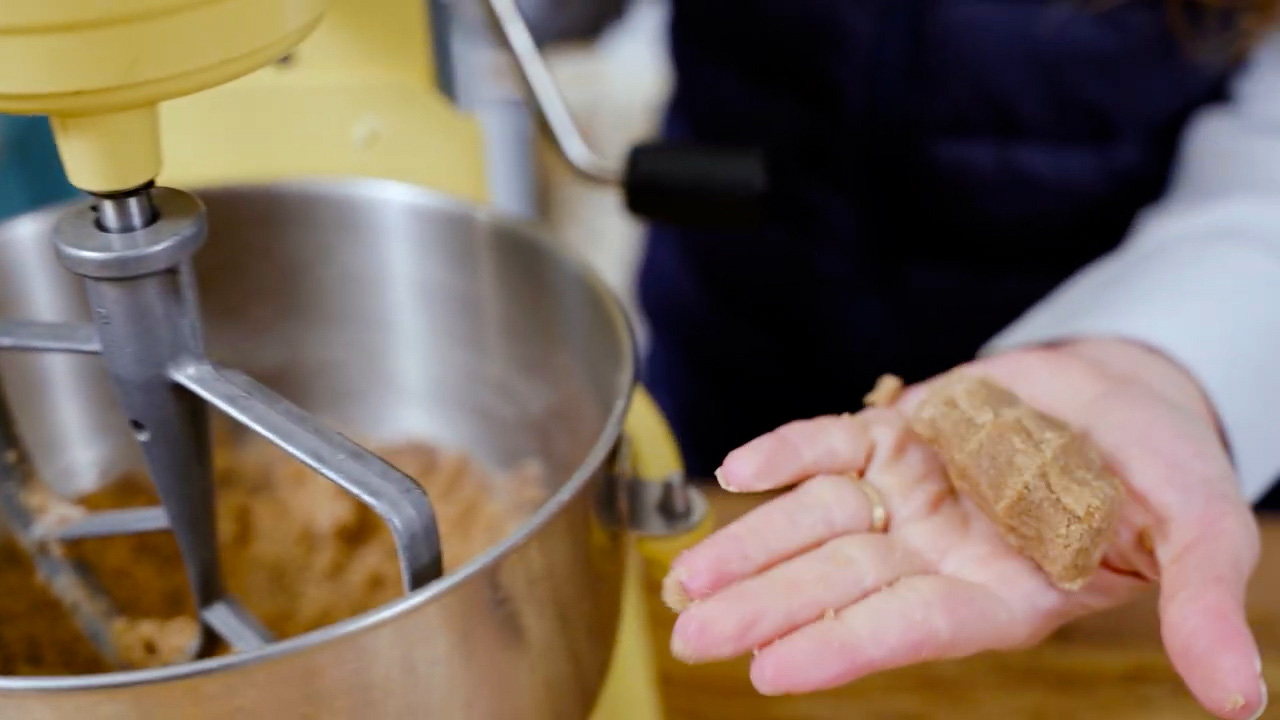 Graham cracker dough in the palm of a hand.