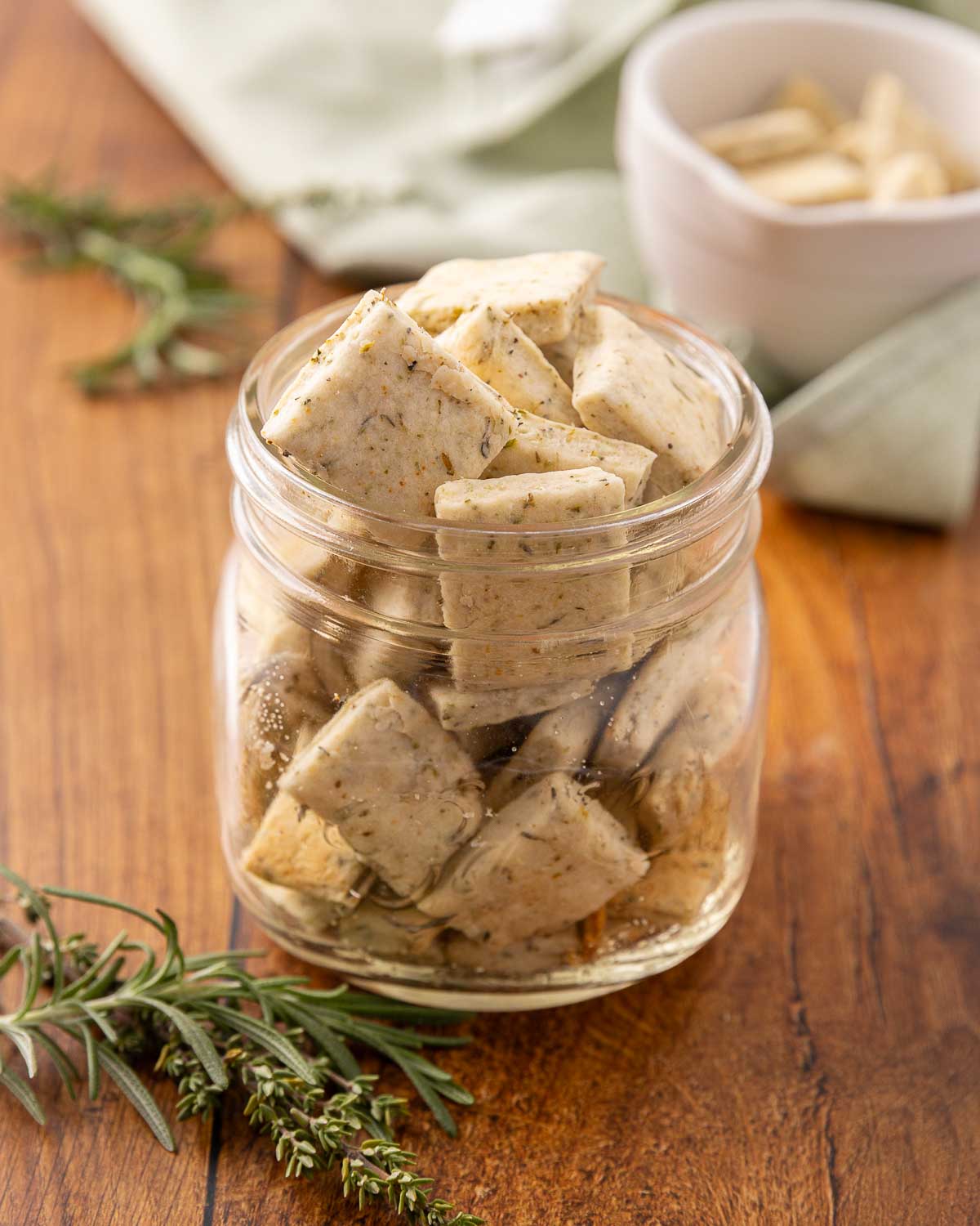 A glass jar full of Italian crackers.