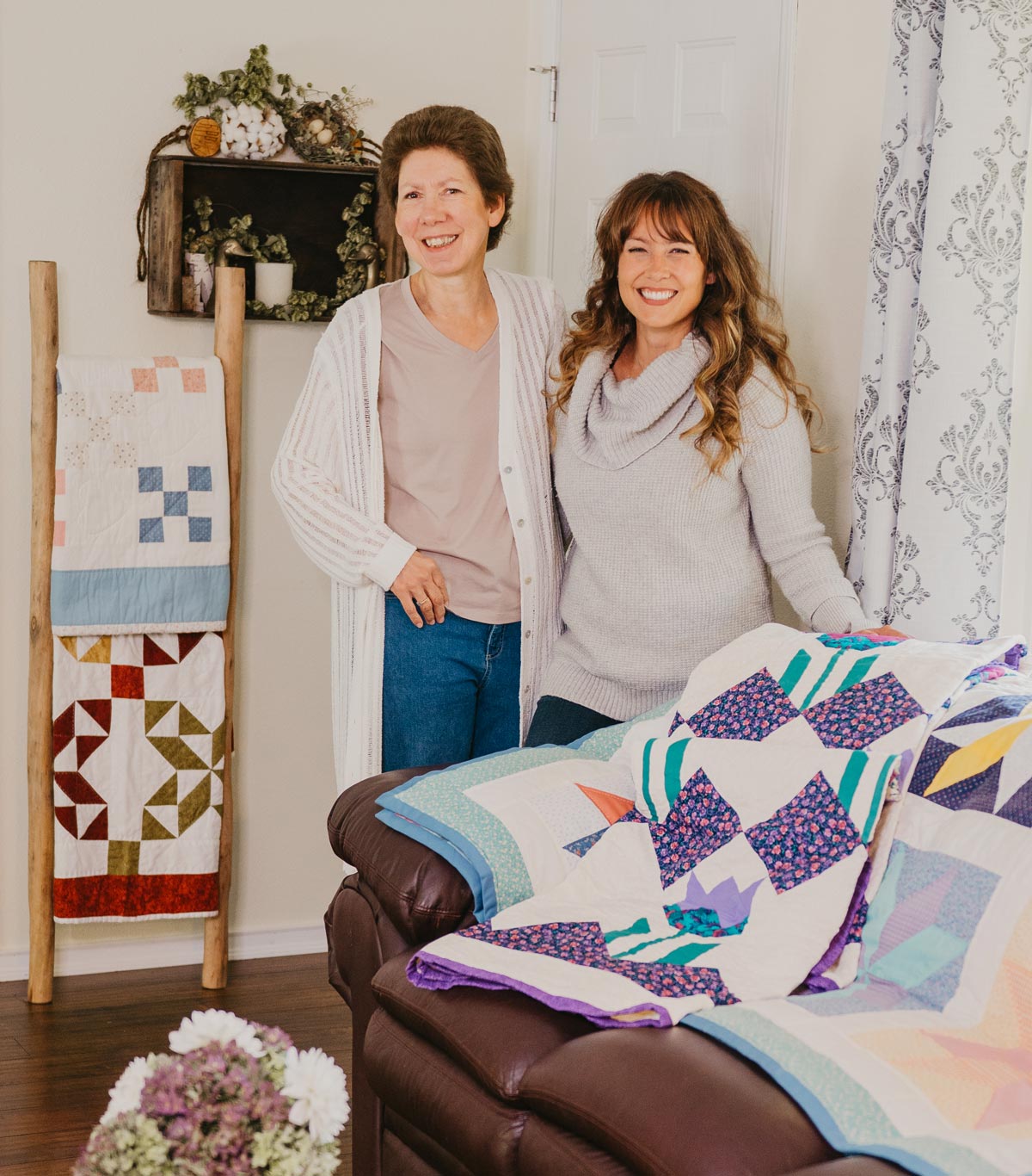 A mother and daughter smiling.