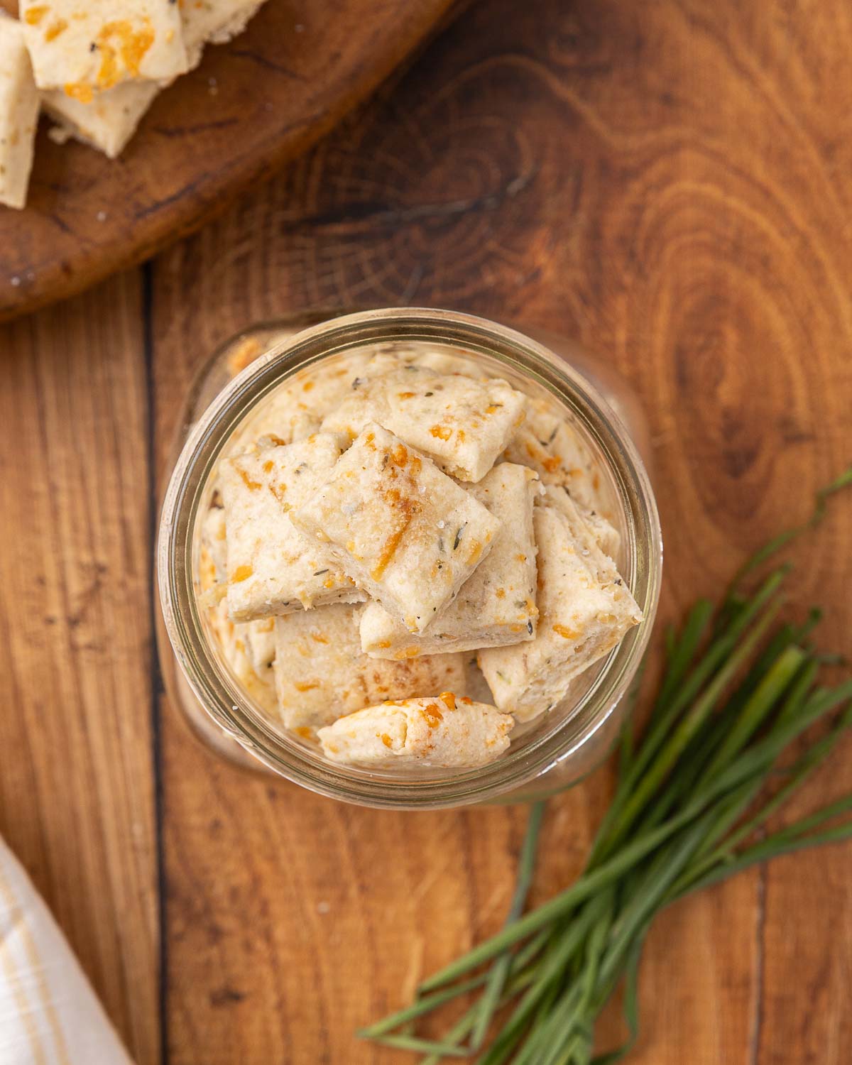Bird's eye view of a glass jar full of sour cream and onion crackers.