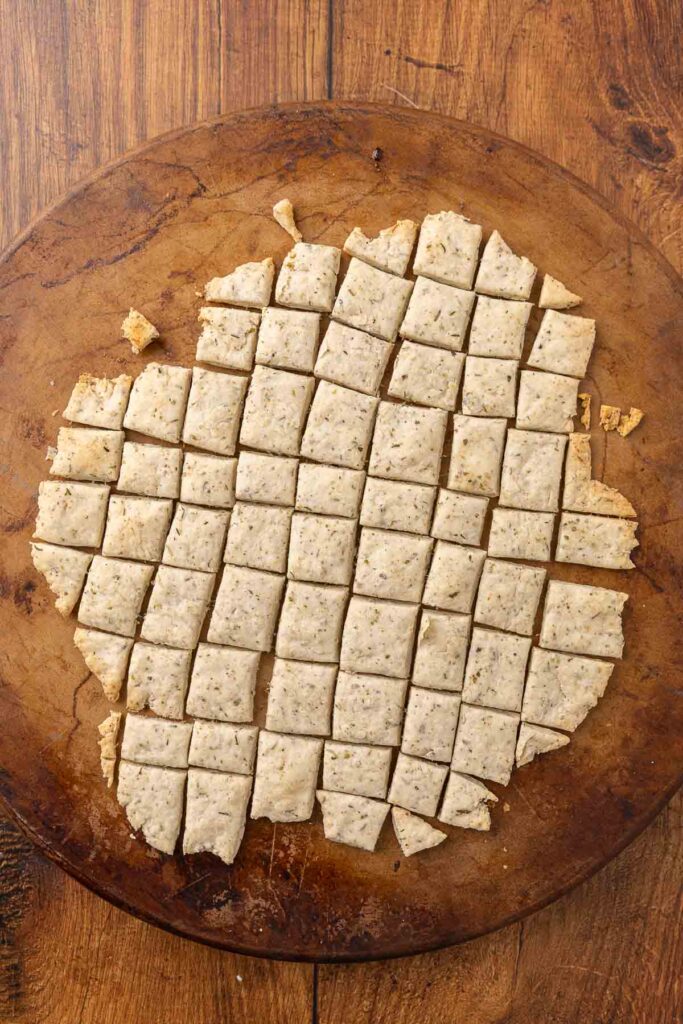 A pizza stone with freshly baked sour cream and onion crackers.
