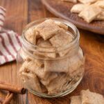 A glass jar full of sweet and salty crackers.