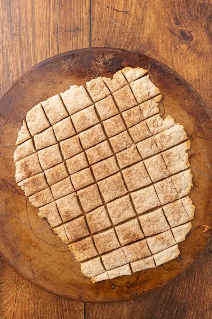 A pizza stone with freshly baked sweet and salty crackers.