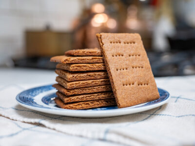 A stack of homemade graham crackers on a plate.