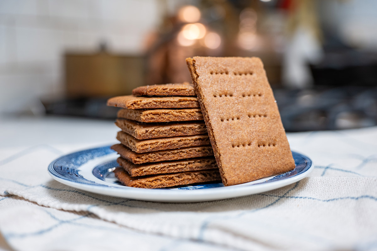 A stack of homemade graham crackers on a plate.
