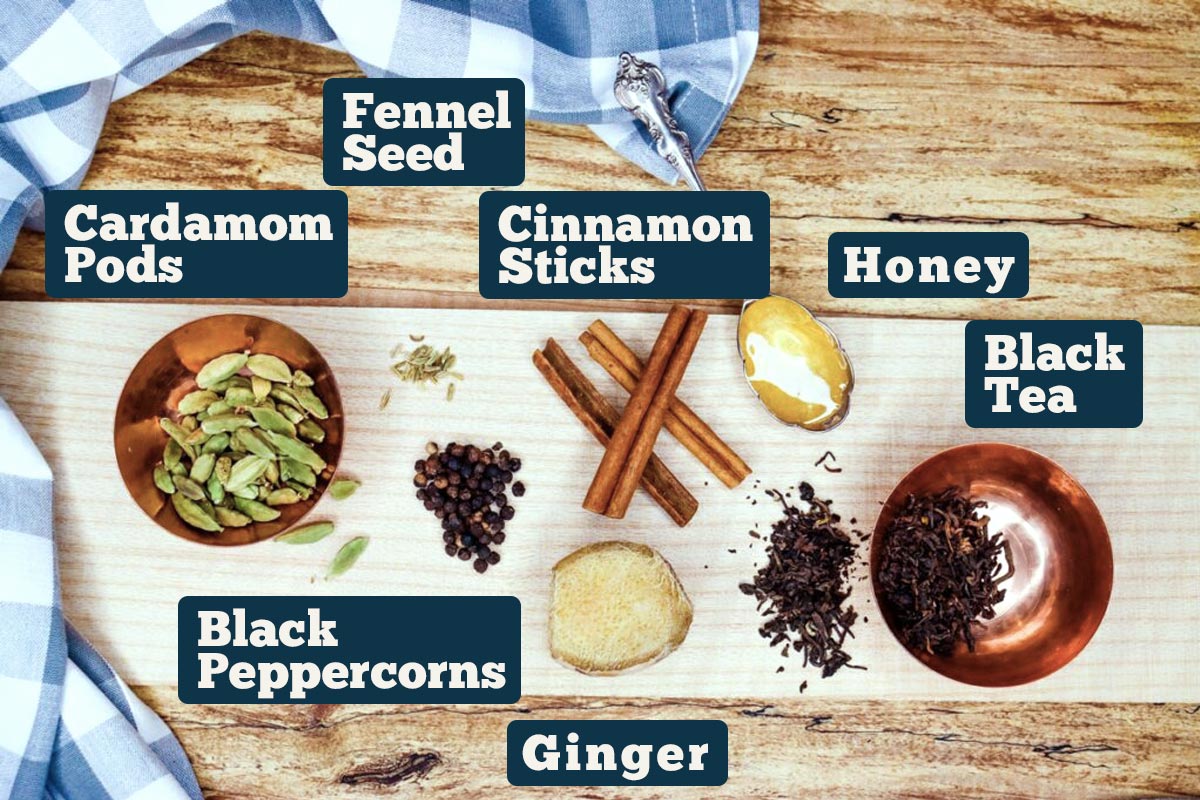 Chai tea concentrate recipe ingredients: cinnamon sticks, honey, black tea, ginger, black peppercorns, and cardamom pods.