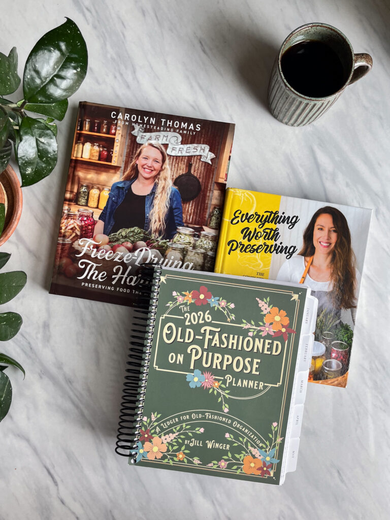 Homestead Living book bundle. Three books on a counter.