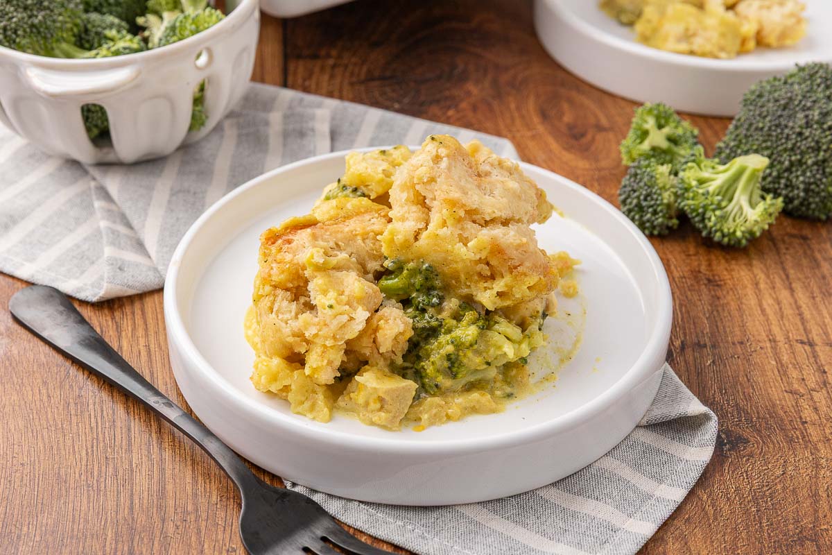 A serving of chicken and broccoli casserole with curry on a white plate.