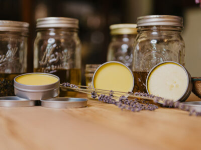Homemade herbal salves and oils on the counter.