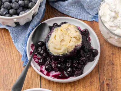 A serving of blueberry dumplings on a white plate.