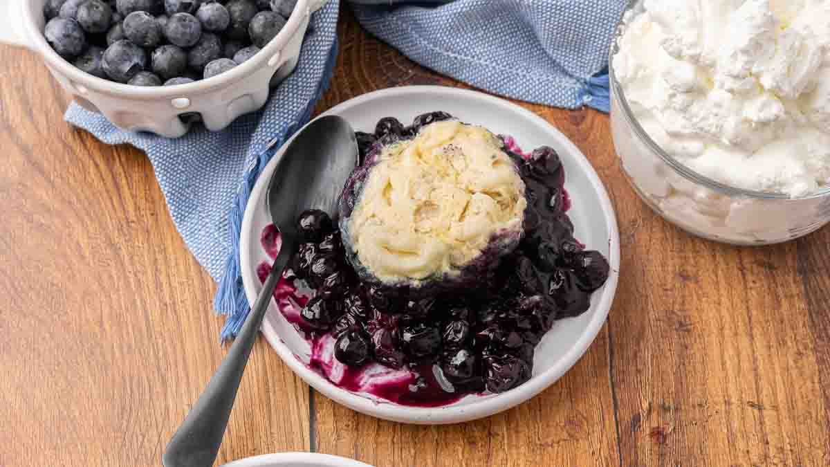 A serving of blueberry dumplings on a white plate.