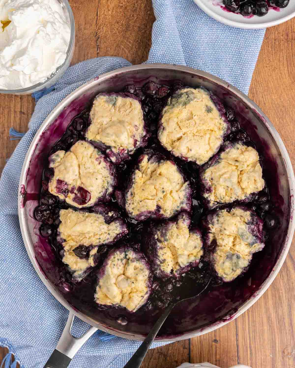 Birdseye view of a skillet filled with blueberry dumplings.
