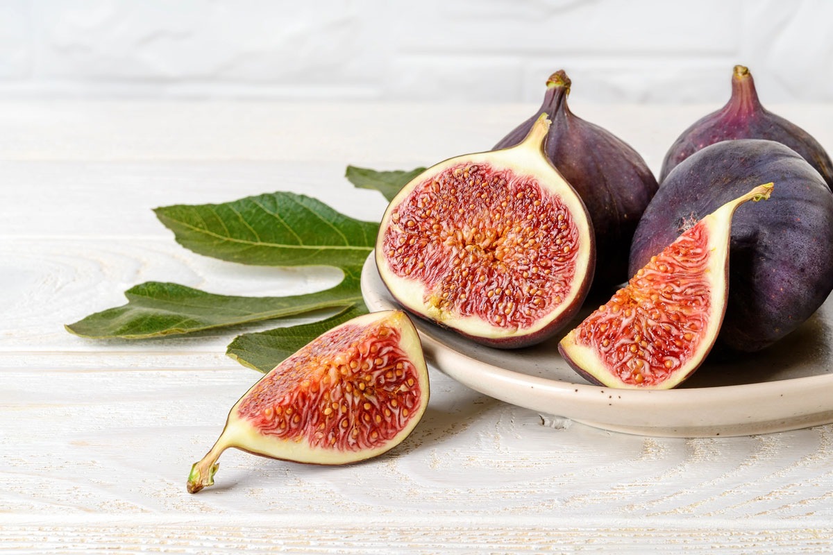Figs on a plate, some cut open.